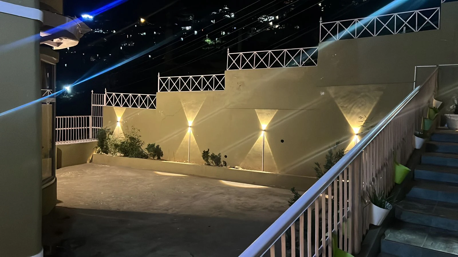 Outdoor seating area with stairs and decorative lighting